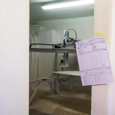 A paper order form in a surfboard factory. 