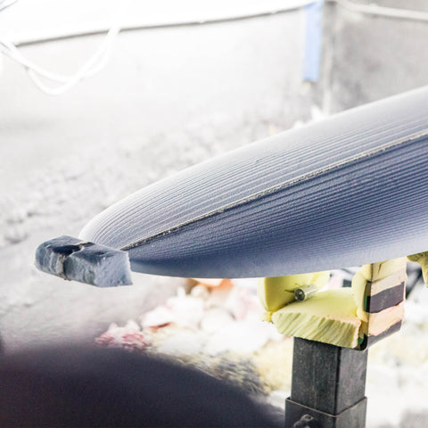 A surfboard blank after being cut by a CNC machine. 