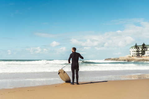 A surfer with an assymetrical custom surfboard design in Portugal. 